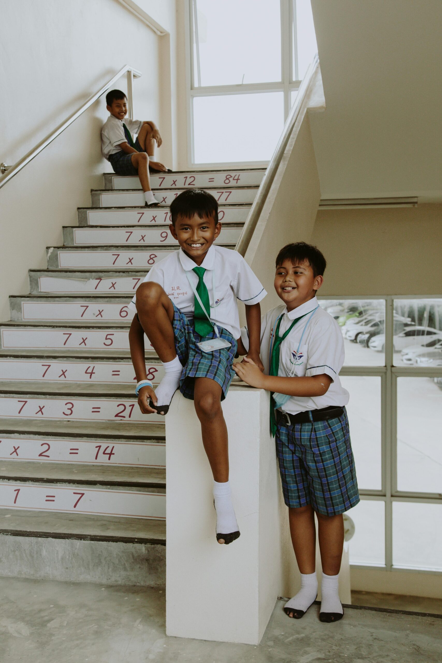 Photo by Ron Lach : https://www.pexels.com/photo/portrait-of-smiling-boys-in-school-uniforms-in-school-staircase-10646597/